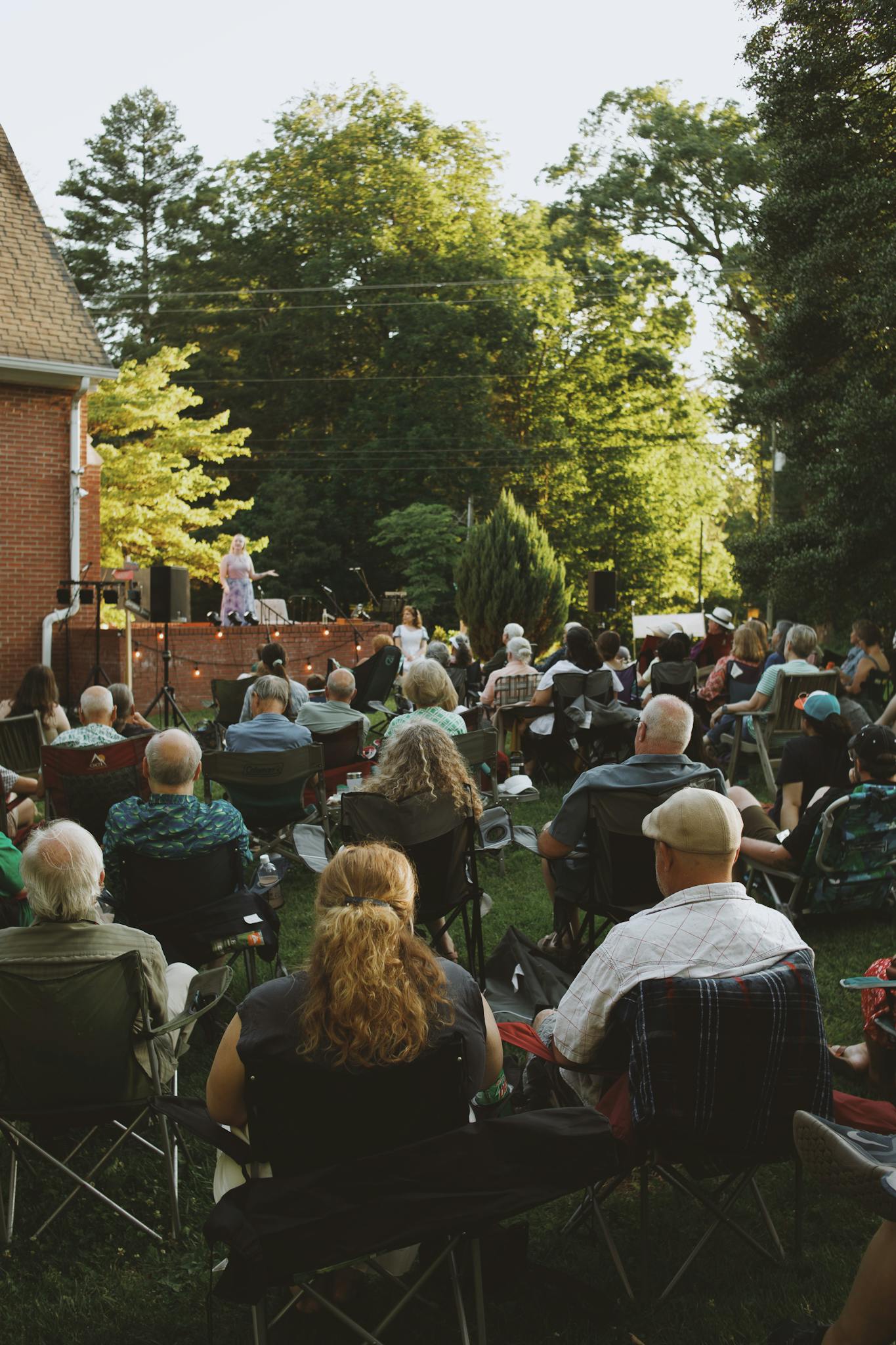 Community gathers for an evening theater performance in Brevard, NC, showcasing local culture.